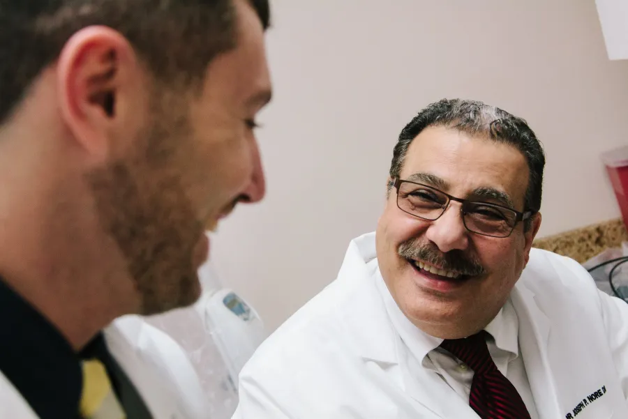 Dr. Nore and a colleague reviewing a patient's care together
